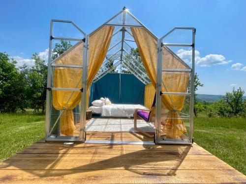 a bedroom in a tent with a bed in it at Langaland Glamping in Susenii Bîrgăului