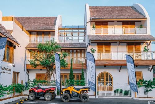 two atvs are parked in front of a house at 108 Villa @ PongYang in Chiang Mai