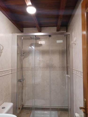 a glass shower in a bathroom with a toilet at Piedad Fernández Fernández Gestión de Inmuebles IV in Burela de Cabo