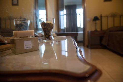 a table with two vases on top of it at Il Cavaliere in Trapani
