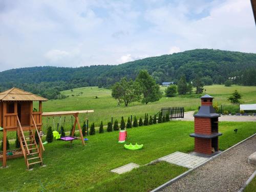 a park with a playground and a play structure at Domki Pod Beskidem in Wysowa-Zdrój