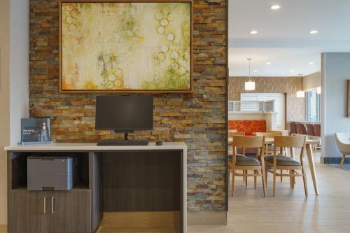 a living room with a desk with a computer on it at TownePlace Suites by Marriott Logan in Logan