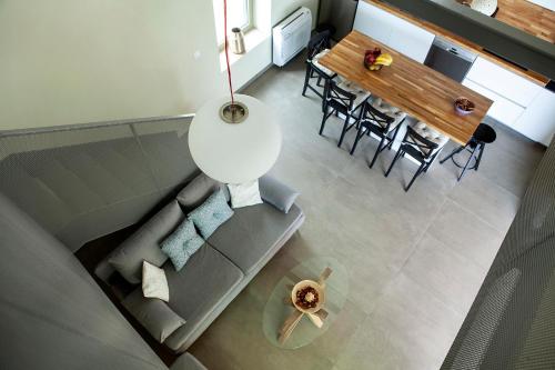 a living room with a couch and a table at Riverstone Villas with private pools in Levktron