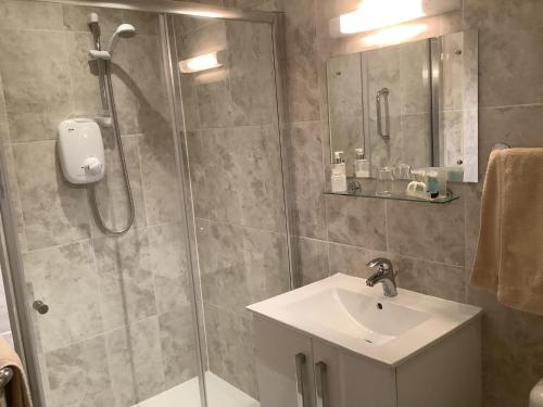 a bathroom with a shower and a sink at Holly House in Ebrington