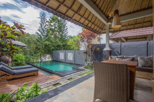 a pool in the backyard of a house at KajaNe Mua at Ubud Bali in Ubud