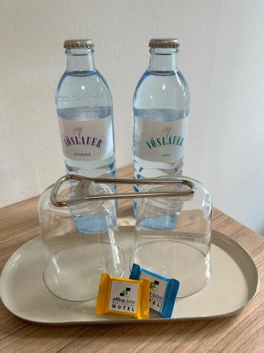 zwei Flaschen Wasser auf einem Teller in der Unterkunft Office Base Bad Vöslau MOTEL in Bad Vöslau