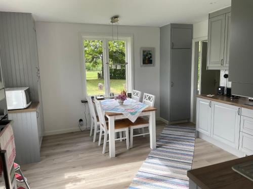 a kitchen and dining room with a table and chairs at Villa Walterängen in Tibro