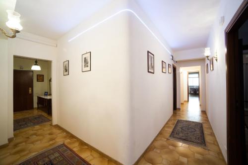 a hallway with white walls and rugs at Il Cavaliere in Trapani
