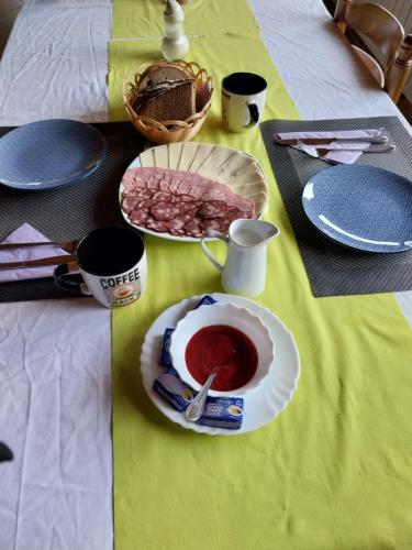 a table with a plate of food on a table at Glamping hišice Orlič in Muta