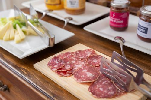a bunch of meat on a cutting board on a table at Hotel Bikini in Rimini