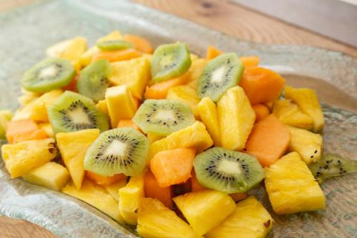 a bowl of fruit with kiwis and other fruits at Hotel Bikini in Rimini