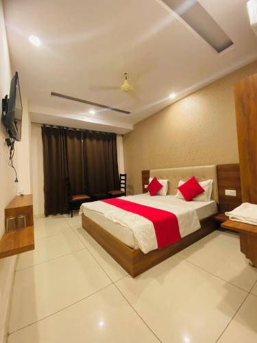A bed or beds in a room at The Holy Stay By Shriji Hotel Group