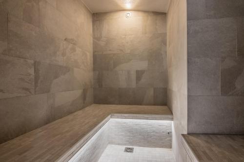 a bath room with a shower with a tub at le clos grillet in La Chambre