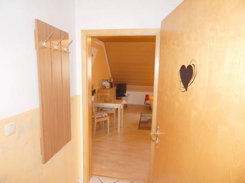 an open door to a room with a table and a desk at Ferienwohnungen Stark in Kelheim