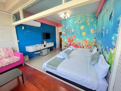 恆春的住宿－墾丁日春民宿，卧室配有一张白色大床和蓝色的墙壁