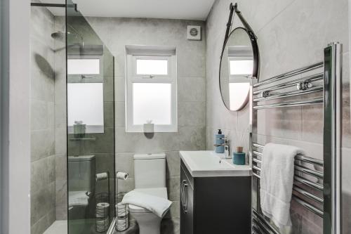 a bathroom with a toilet and a sink and a shower at Charles Alexander Short Stay - St Davids Rd North in Lytham St Annes