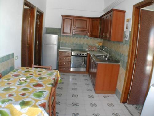 a kitchen with a table and a kitchen with a sink at Cavadozza by Caseaponza it in Ponza