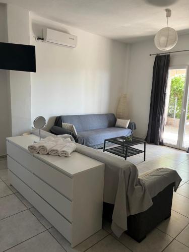 a living room with a bed and a couch at Alexandros Apartments in Dhrepanon