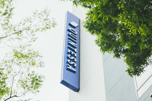 a sign on the side of a building at Quintessa Hotel Kokura Comic & Books in Kitakyushu