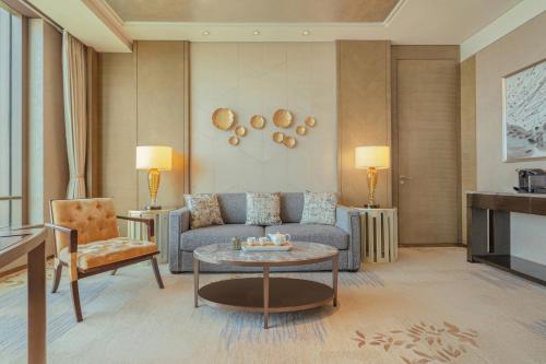 a living room with a couch and a table at Shangri-La Jinan in Jinan