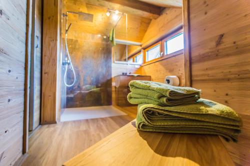 a stack of towels sitting on a table in a tiny house at Chalet Hüttenzauber in Mehlmeisel