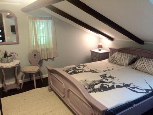 a bedroom with a large bed and a table at Bergbach in Ramsau