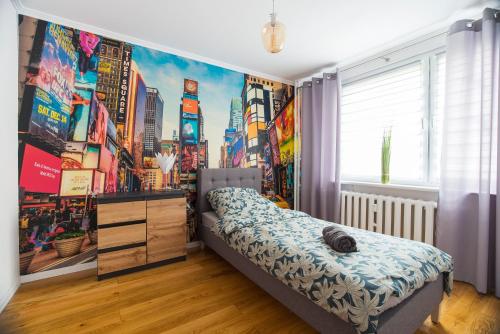 a bedroom with a city mural on the wall at Apartament Lelewela in Częstochowa