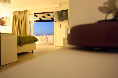 a living room with a bed and a view of a room at Lindian Jewel Hotel and Villas in Líndos