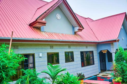 a house with a red roof at Safari Park House in Arusha