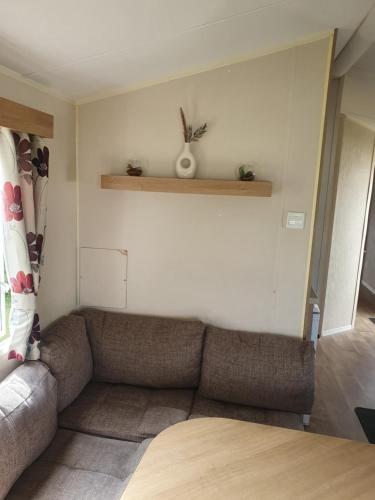 a living room with a couch in a room at Fantasy Island King Fisher 8Berth 402 in Ingoldmells