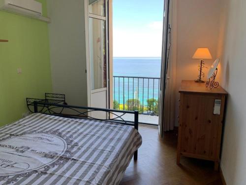 a bedroom with a bed and a view of the ocean at Villa Cannes directly on the sea in Cannes