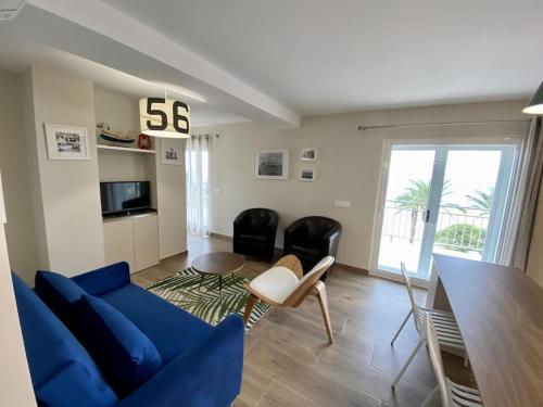 een woonkamer met een blauwe bank en een tafel bij For a Stay Horizonte Mar in Cambrils
