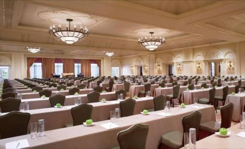 a large room with tables and chairs and chandeliers at Unique 1BR Suite Condo Located at Ritz Carlton-Key Biscayne in Miami