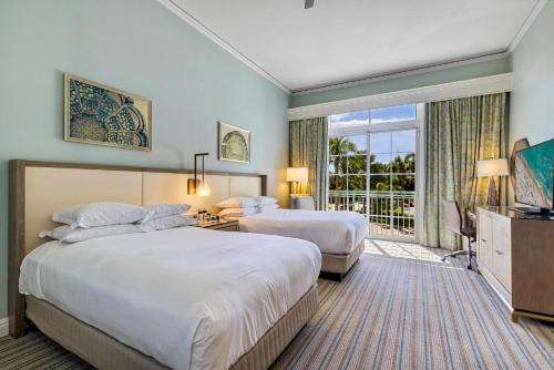 a hotel room with two beds and a television at Lovely Deluxe Unit Located at Ritz Carlton - Key Biscayne! in Miami