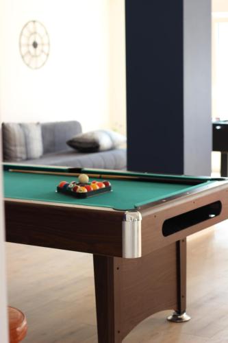 a pool table with a green cloth on it at ''Bjonda'' 200m2 on two floors - Game Room, Hot Tub and Kids Zone - large balconies on each floor in Mlini