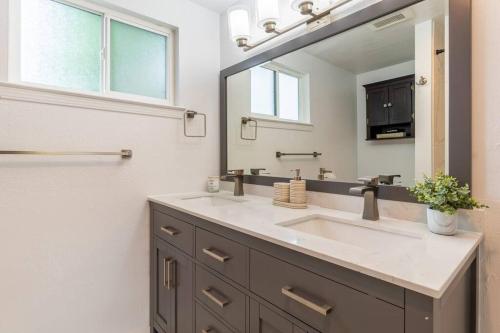 a bathroom with a sink and a mirror at Wren Home in Concord