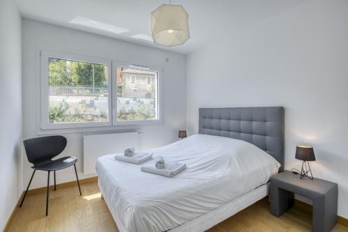 une chambre avec un lit, une chaise et une fenêtre dans l'établissement View Point Lac d Annecy, à Annecy