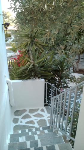 a white bench sitting next to a white fence at Amaranthos Skiathos View in Megali Ammos