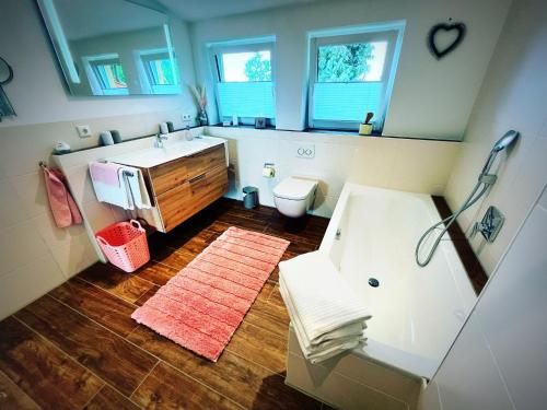 a bathroom with a sink and a toilet at 2023 NEU erbaute luxuriöse Ferienwohnung im Chaletcharakter mit Schlossblick in Halblech