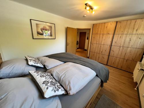two beds in a bedroom with wood paneling at Naturstrand Apartment - 86m² - 4 Betten - Parkplatz in Hagermarsch