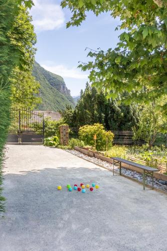 a group of balls sitting on the ground next to a bench at le clos grillet in La Chambre