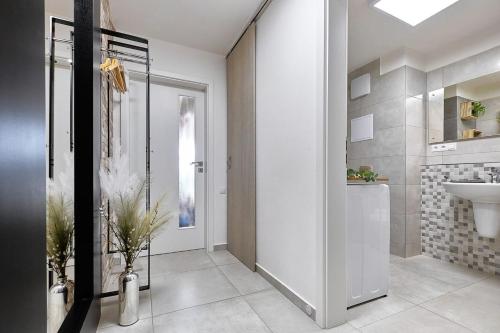 a bathroom with a toilet and a sink and a mirror at Charming and quiet apartment in Lipno nad Vltavou
