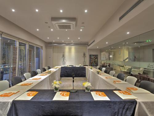 a large conference room with a long table with chairs at Polis Grand Hotel in Athens