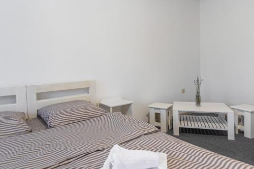 a bedroom with two beds and a table and two tables at ROMANTIK in Solotvyno