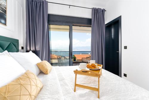 a bedroom with a bed with a view of the ocean at Luxury villa Verbenico Hills- amazing sea view, pool with whirpool and waterfall, beach, in famous wine region - Your holiday with style in Vrbnik