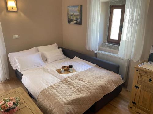 a bed with a tray of food on top of it at Casa Mia in Pićan