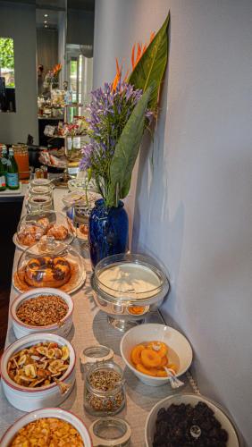 a table with many plates of food on it at Hotel Villa Cansignorio in Lazise