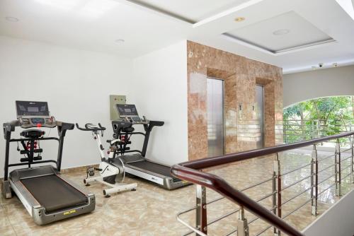 a gym with two treadmills and two exercise bikes at Khang Thịnh Hotel Long Thành in Long Thành