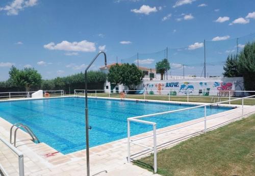 a large swimming pool with blue water at Casa rural La Azuleja de Alatoz in Alatoz