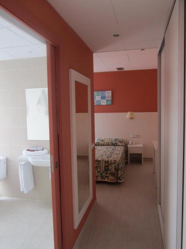 a room with a door leading to a bedroom at GHT Balmes, Hotel-Aparthotel&SPLASH in Calella
